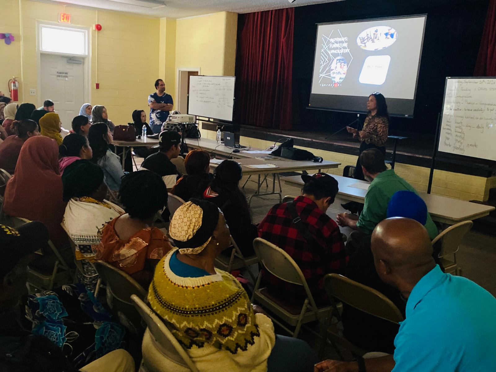 Dr. Samira Khan presenting to a diverse community audience